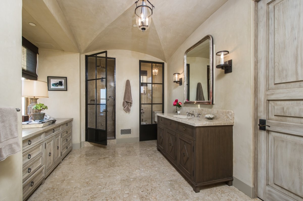 and-the-bathroom-has-glass-paneled-doors-to-the-toilet-and-shower