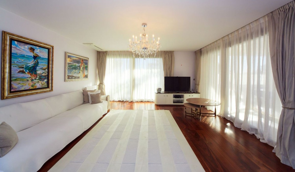 Spacious living room with walnut floors