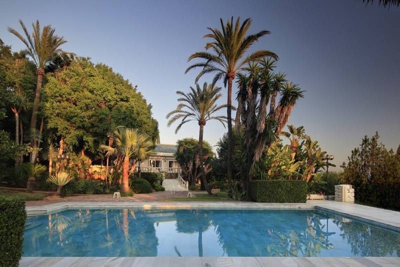 The property has a large pool and stunning gardens