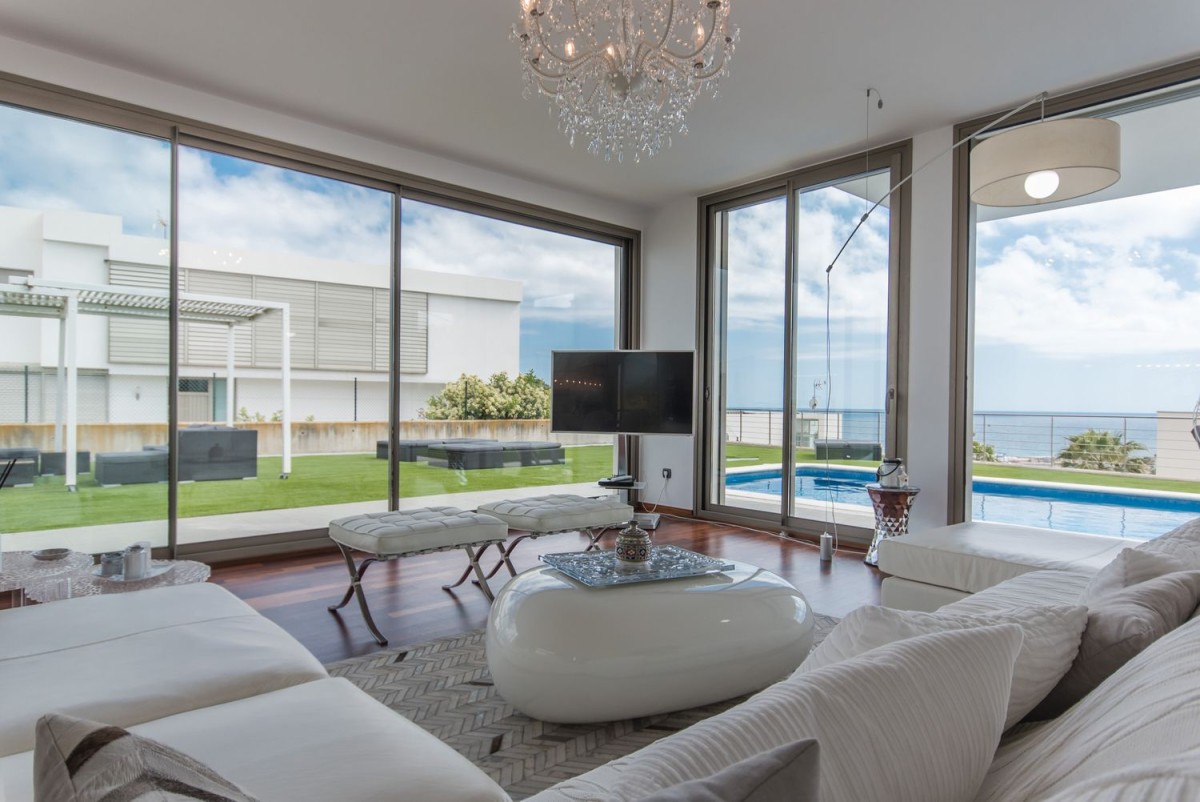 The modern living room overlooks the large garden The modern living room overlooks the large garden