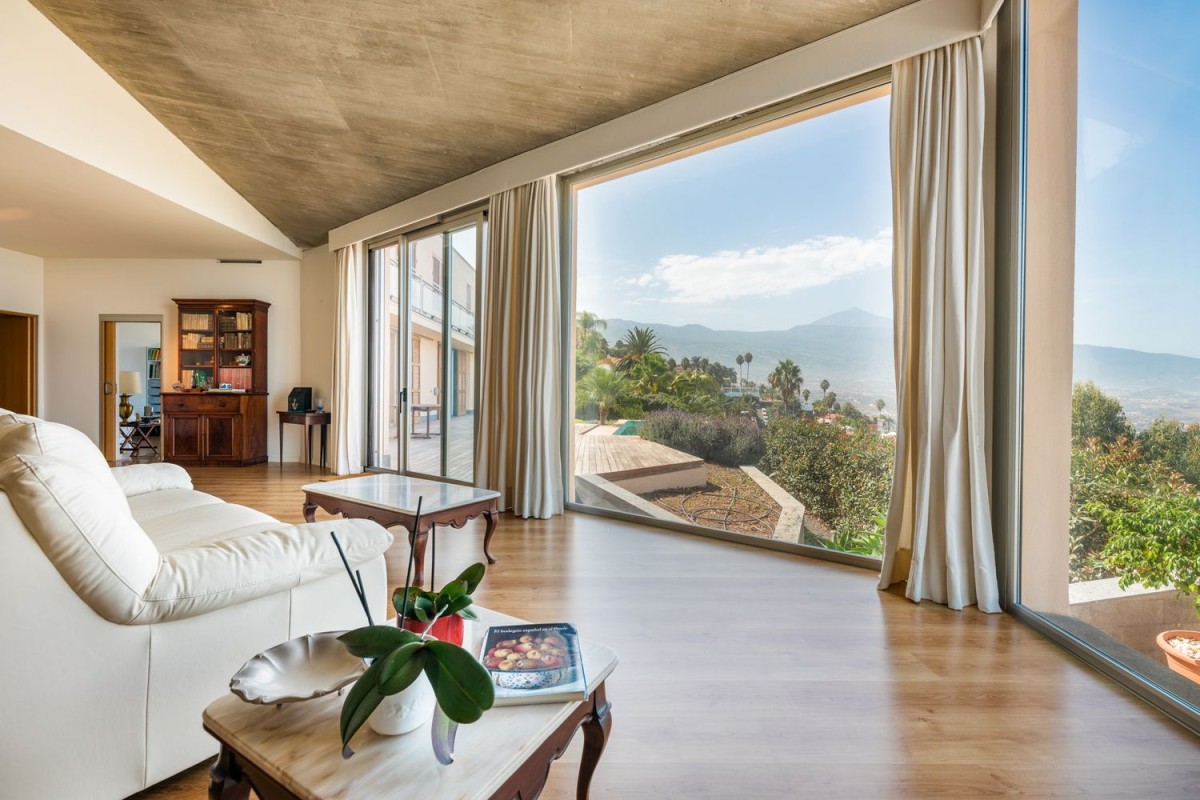 The property has an open living area with large floor-to-ceiling windows