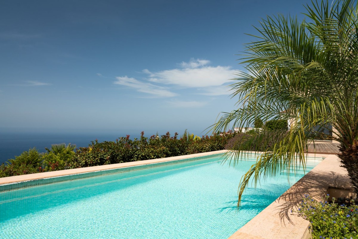 The garden is home to a stunning pool with spectacular sea views