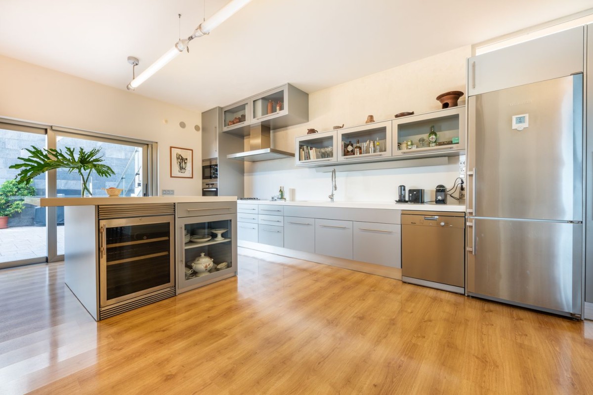 The kitchen is modern and spacious