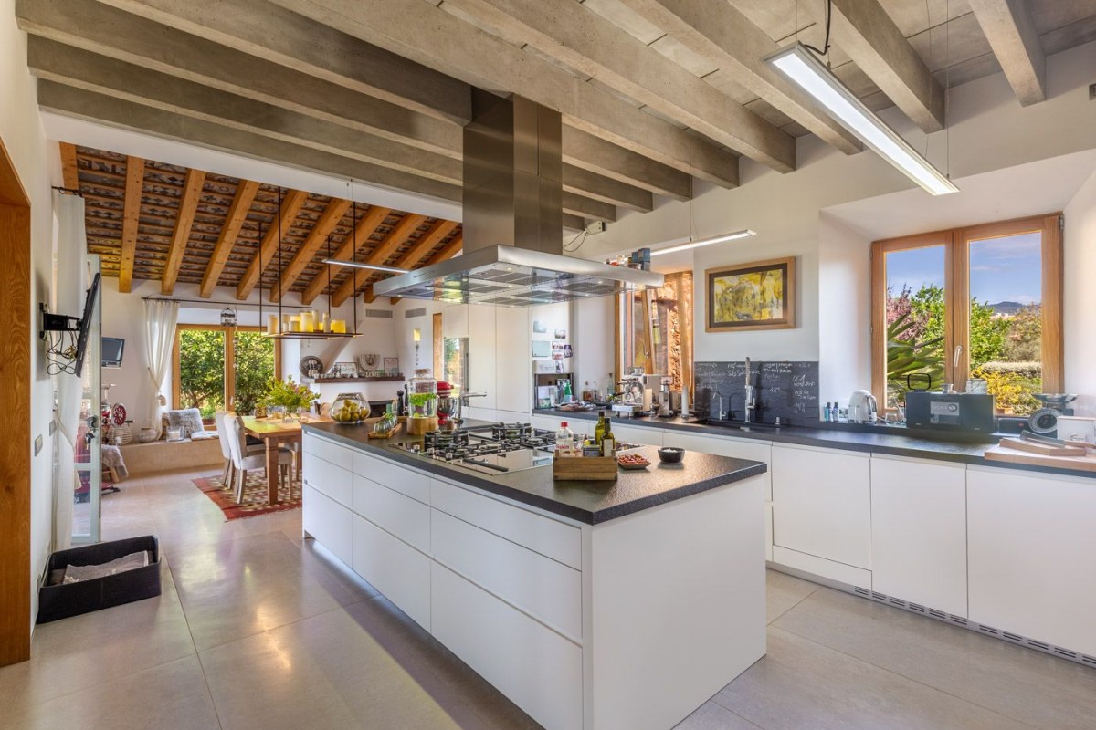 The modern kitchen compliments the traditional wooden beams