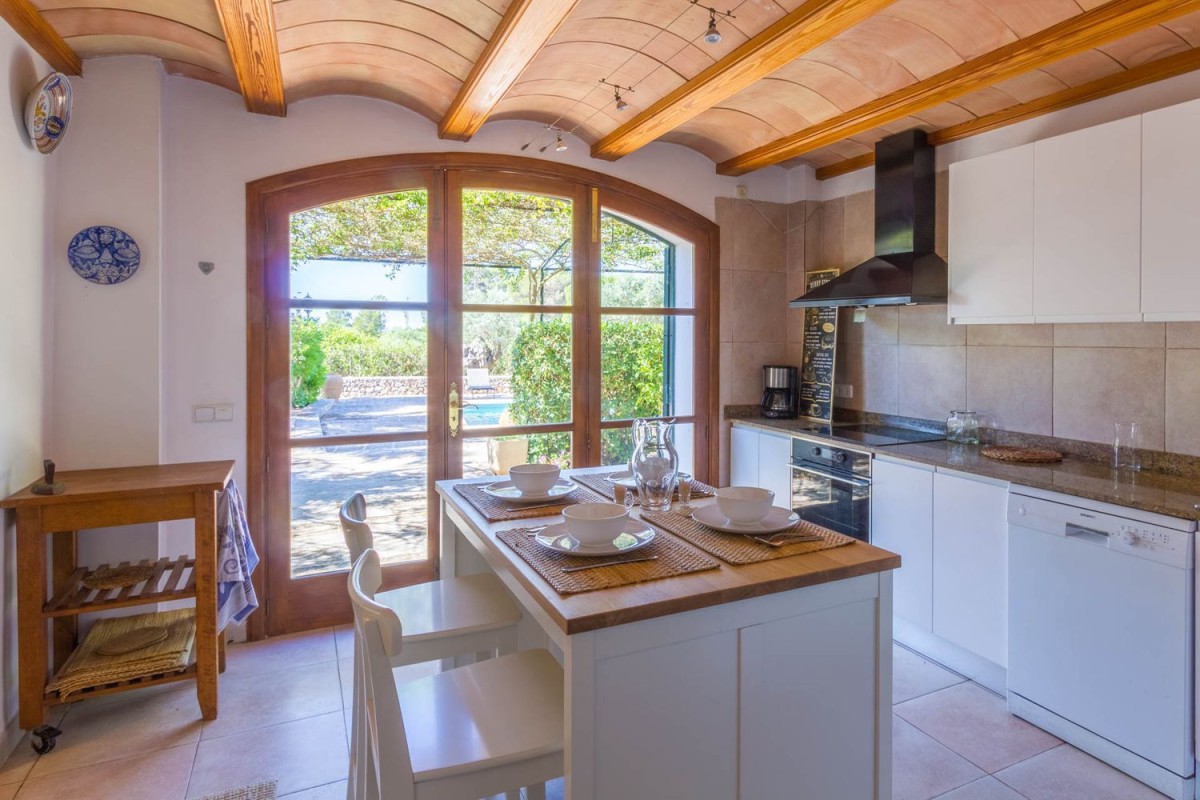 The kitchen is bright and has direct access to the terrace