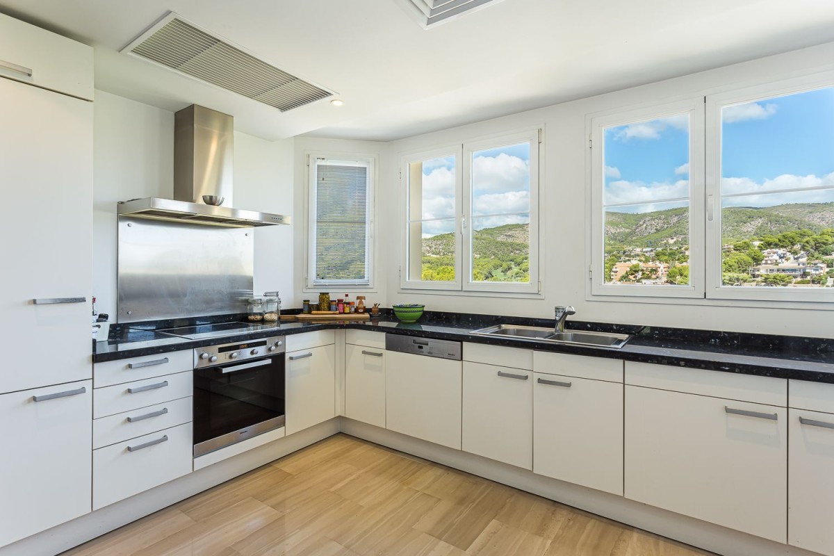 The kitchen is modern and spacious