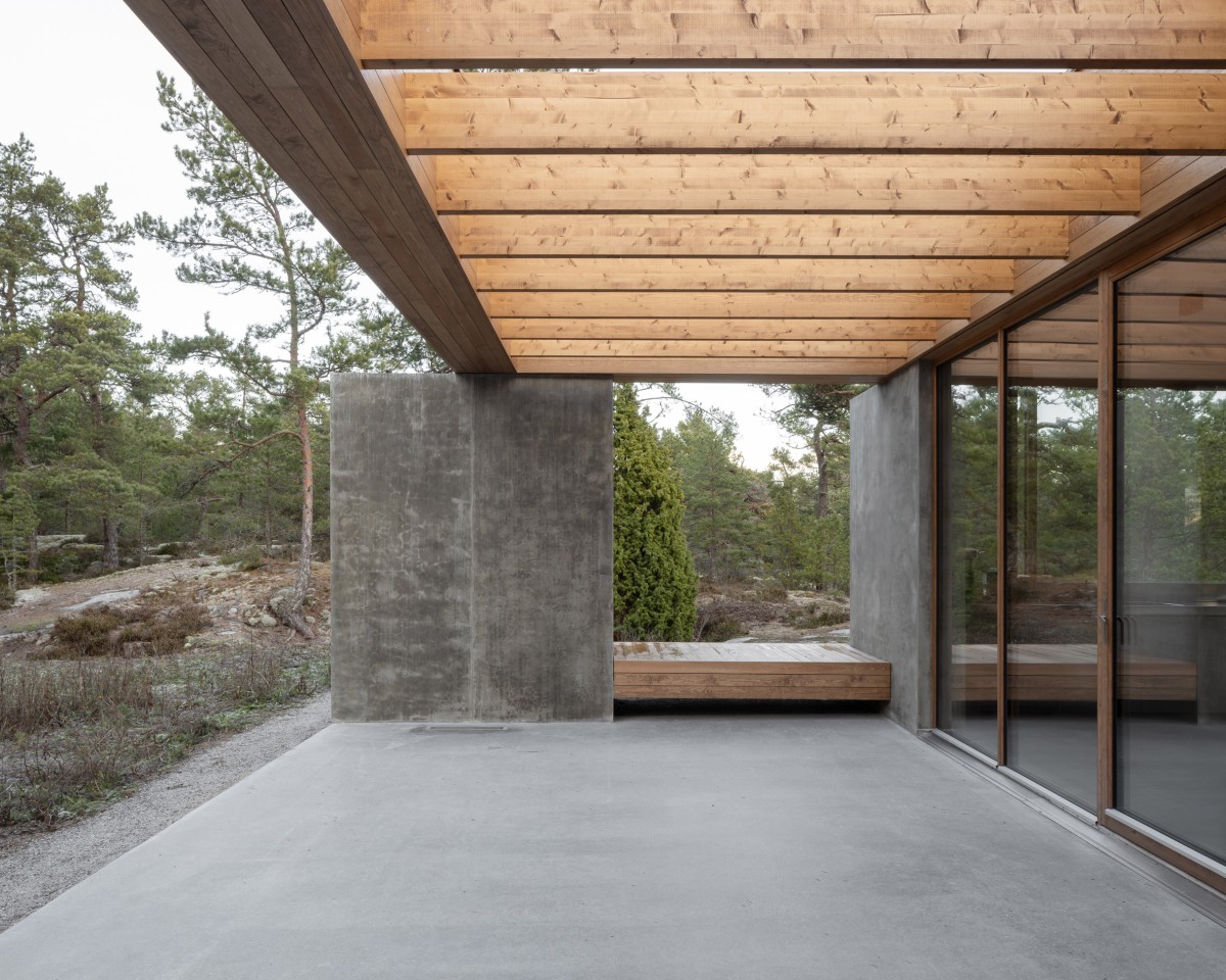 En la terraza, cubierta por una pérgola de madera, el hormigón continúa hacia al exterior.