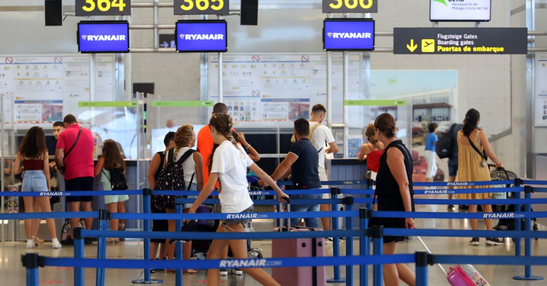 File - Hundreds of tourists queue at Ryanair boarding gates at Costa del Sol Airport,